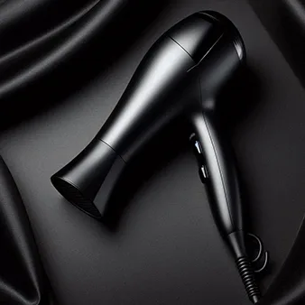 Black hair dryer placed on a rich, black fabric backdrop. The glossy finish of the hair dryer contrasts subtly with the soft texture of the fabric, emphasizing its modern and stylish design