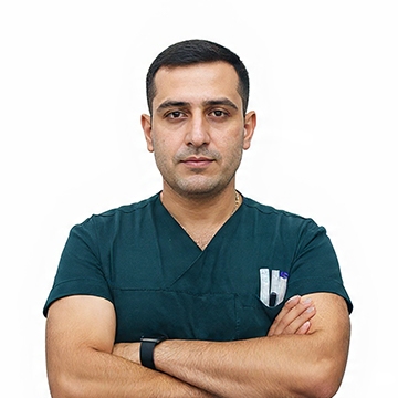 Dr. Onez Ozkaya, lead hair transplant surgeon, wearing green scrubs