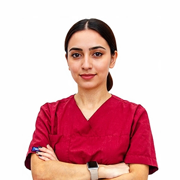 Dr. Nader Akcelik, hair transplant specialist, wearing red scrubs