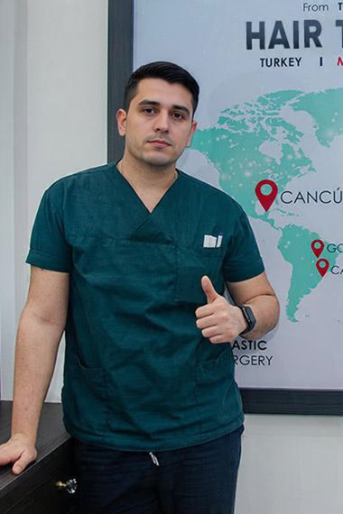 Hair transplant doctor in scrubs with Cancun location marker